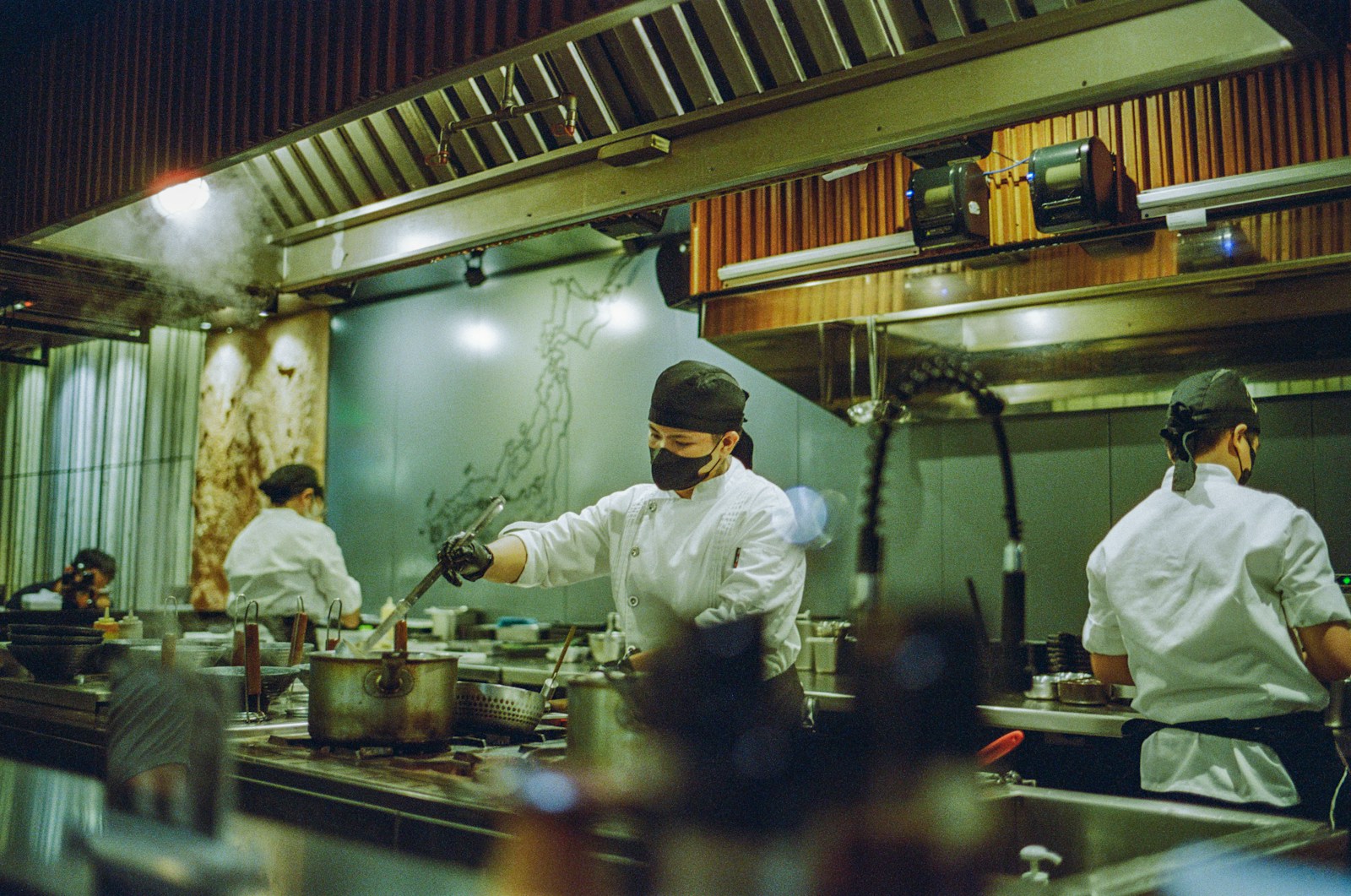 A group of chefs preparing food in a kitchen